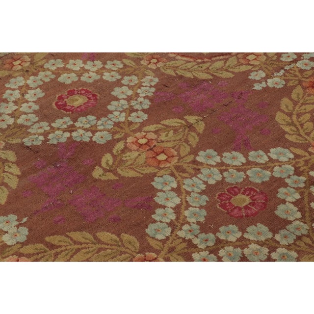 This 4x9 vintage French Art Deco runner, hand-knotted in wool circa 1950–1959, features an allover trellis of floral...