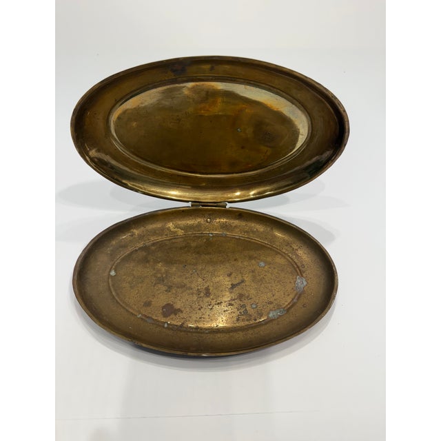 Traditionally used in the mid-20th century as a functional crumb catcher or personal ash box, these heavily decorated...
