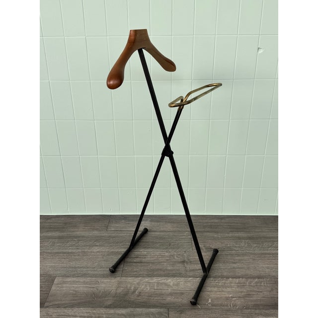 Folding valet stand from the 1950s Black metal frame. Beechwood accessory (for storing shirts and sweaters). Brass...