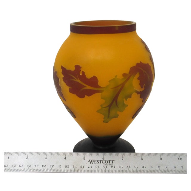 A unique yellow and brown cameo glass flower made for Teleflora in the 1970s. The body has leaves and fruit in relief...