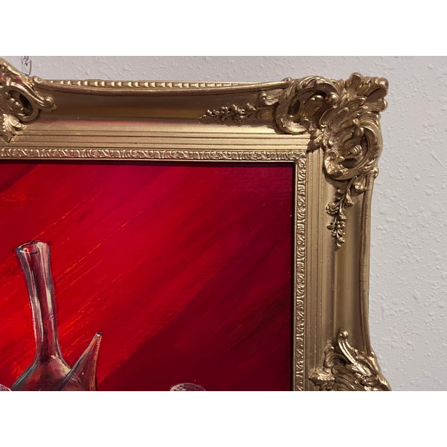 This striking still life painting exudes warmth and richness, set against a deep red background that enhances the vibrancy...