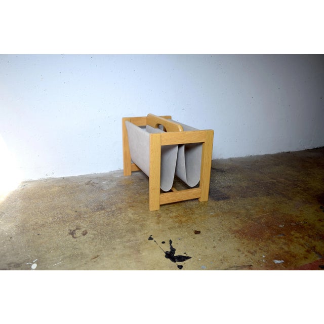 This is a simple magazine rack from the 1970s. Made in Denmark. The wooden frame is made of oak, and the light gray fabric...