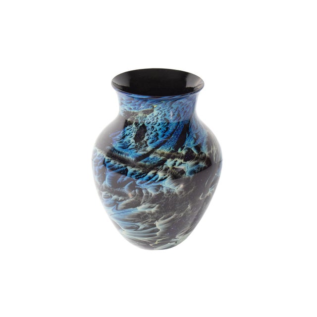 A 1985 art glass vase by the American glass artist Josh Simpson (born 1949). This vase features a black, blue, and white...