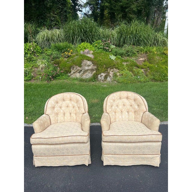 Pair of Tufted Button Back Swivel Chairs in a cream color with brown piping. These chairs swivel and rock. Nice neutral...