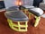 Painted wood with cushioned black vinyl seats. Note veneer loss under one section. Unseen and does not affect use or the...