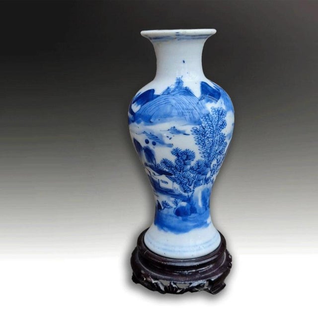 A finely decorated Chinese Qing Dynasty porcelain vase with underglaze cobalt blue decoration. The vase depicts mountain...