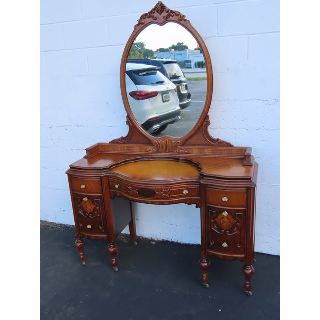 This beautiful antique vanity table was crafted in the 1920s and showcases the timeless elegance of the Jacobean Revival...
