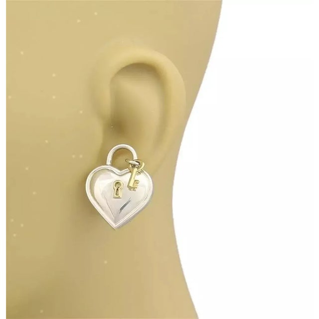 An authentic pair of earrings from Tiffany & Co. They are crafted in sterling silver with 18k yellow gold accent in a fine...