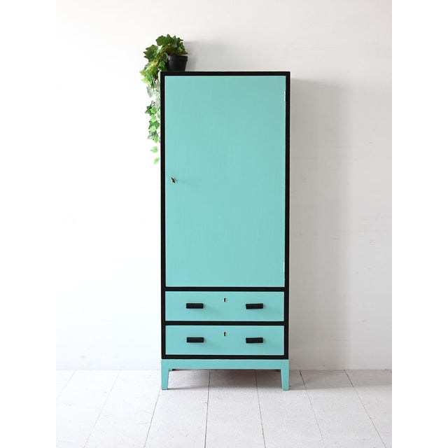 Scandinavian shabby wardrobe in light blue painted wood with hinged door and drawers. An original and functional piece of...