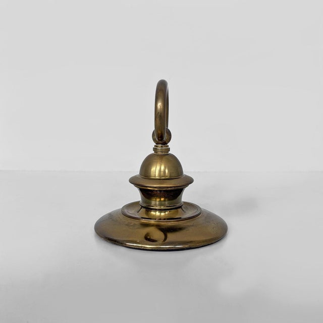 Italian mid-century modern brass doorstops, 1950s Pair of turned brass doorstops, featuring a flared circular base and a...