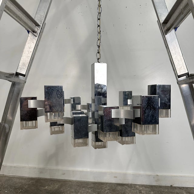 This iconic chandelier is by Italian company Gaetano Sciolari produced in the 1970. The chandelier is composed of 17 cube...