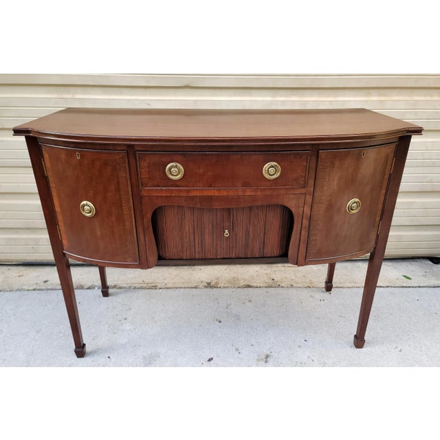Featured is a short compact 48" Long Vintage Sheraton Style Mahogany Sideboard/Server with a single drawer above tambour...