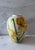 Vintage mid century ceramic vase with speckled background and hand painted yellow iris flowers and green leaves. Unsigned