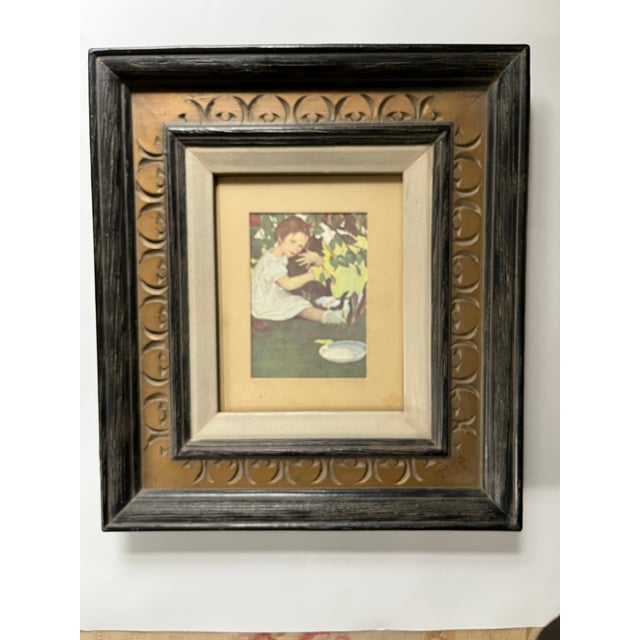 "I Love my Little Cat" is a Jesse Willcox Smith (American- 1863-1935) print that illustrates a child holding a black cat....