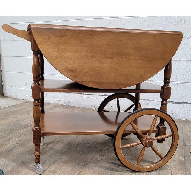 This is a beautiful vintage solid maple drop leaf bar cart or tea cart. It features full-sized bottom shelves, a drawer...