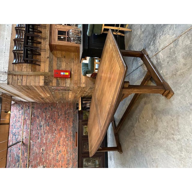 Magnificent barrel-shaped family table. Its base is made of solid oak and its beautiful top is oak veneer. Its unusual...