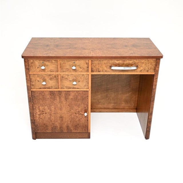 A stunning original Art Deco burr walnut desk. This was made in England, it dates from the 1930’s. It is an unusual...