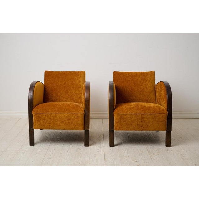 Pair of Swedish art deco armchairs. These vintage armchairs are made in Sweden around 1930 with classic rounded armrests...