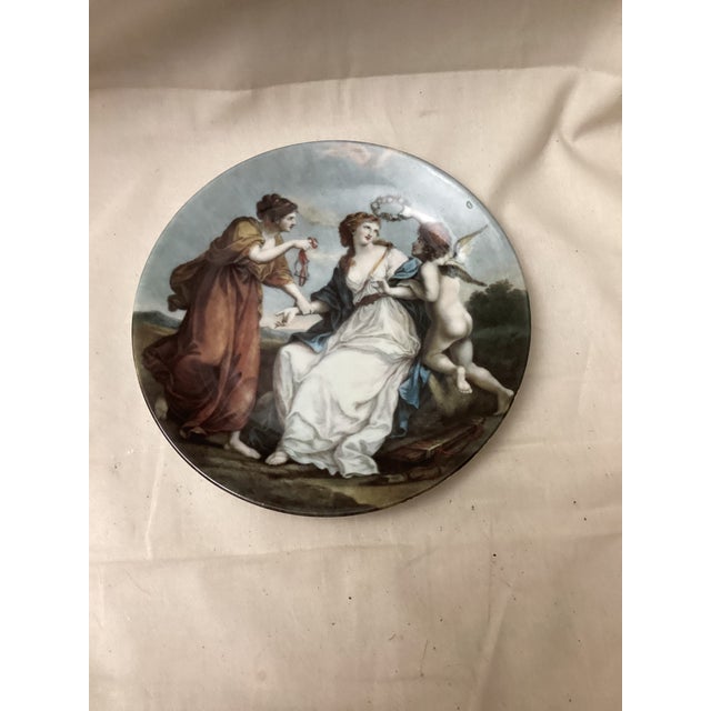 This elegant vintage porcelain plate features a beautifully hand – painted classical scene. Adorned with graceful figures...