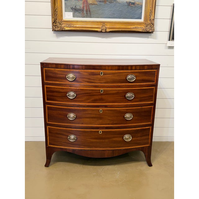 Early 19th Century mahogany bowfront chest of drawers of nice proportions, having a lovely crossbanded figured top above...