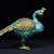 This is a striking vintage figurine of a peacock, crafted using the traditional cloisonné enamel technique. The bird's...
