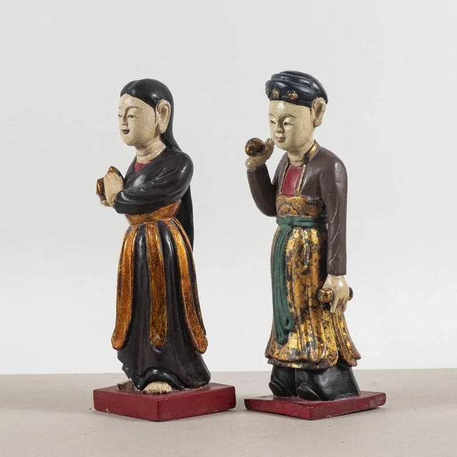 This pair of wooden sculptures is an example of craftsmanship that reflects the aesthetics and traditions of asian...