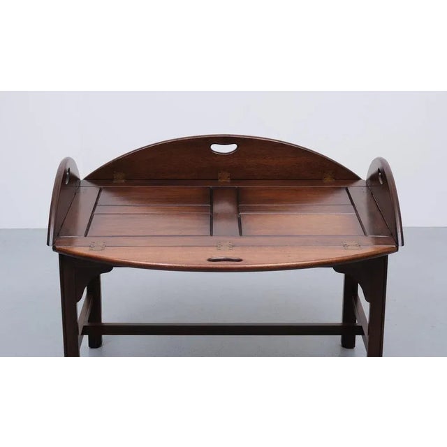 Very nice classic tray table. Tick solid mahogany tray. Fits perfect on the table. Brass hinges. Good quality table....