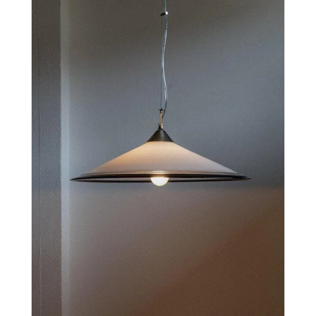 This large vintage murano ceiling light from the 1970s features a timeless conical silhouette crafted from white murano...