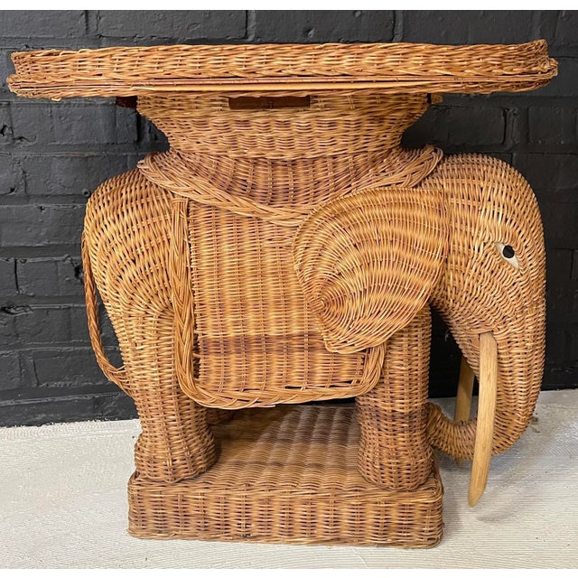A midcentury rattan elephant shaped table with a tray top with a Rosenthal Netter label- founded in 1950 as an importer...