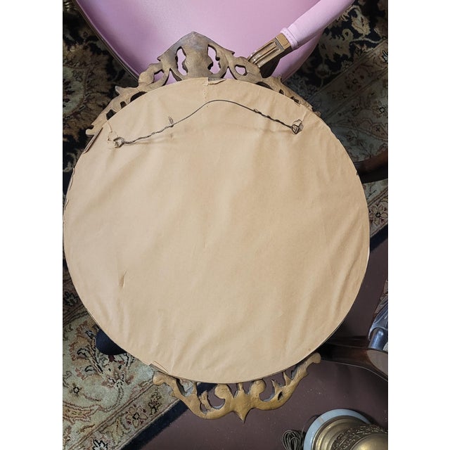 Fine antique art deco etched gilt round mirror with Greek key design. Measuring20 inches wide by 26 inches tall. In fine...