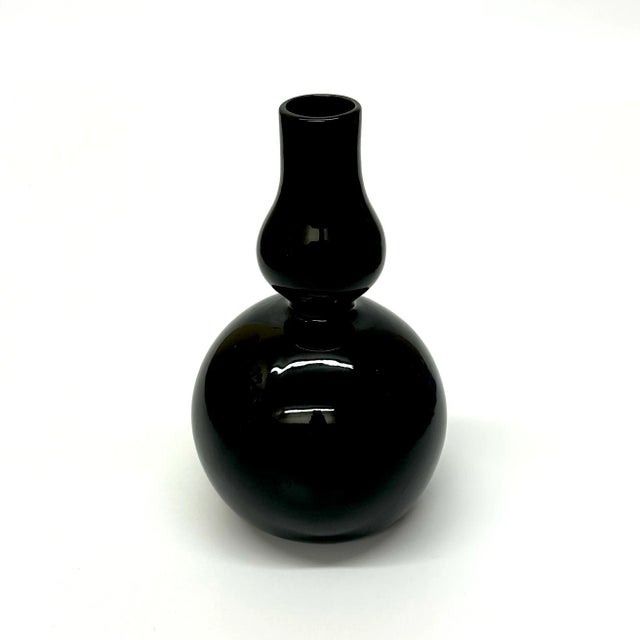 Black and brass vases, group of 5. A glamorous group of curvy mixed ceramic, glass, and brass vases from the mid-20th...