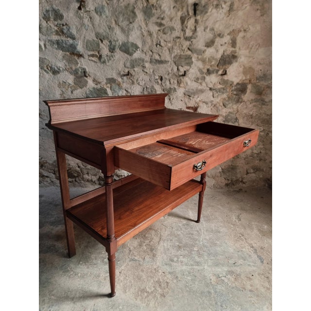 Antique mahogany console table dating from around 1900, originating from France. The piece features a large full-width...