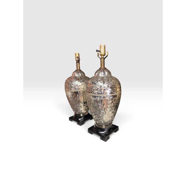 Striking matched pair of vintage silvered glass table lamps featuring richly detailed botanical decoration and elegant...