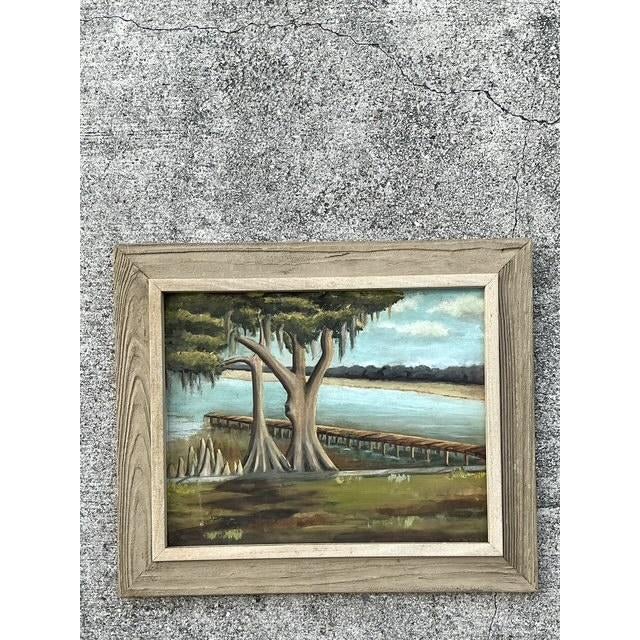 This evocative vintage oil painting captures the serene, timeless beauty of a Southern lakeside landscape. Featuring...