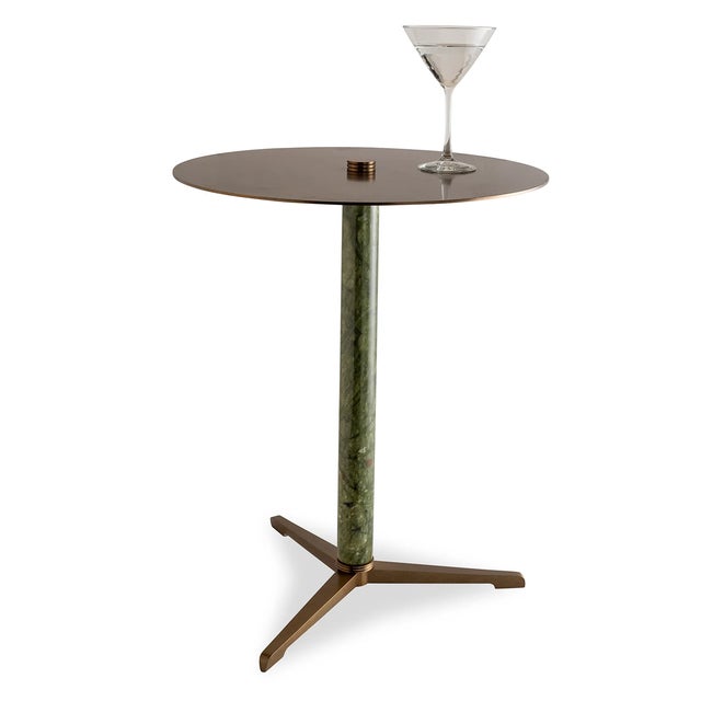 Natural green stone marble column turning is accented with an aged brass finished metal round top. The green marble center...
