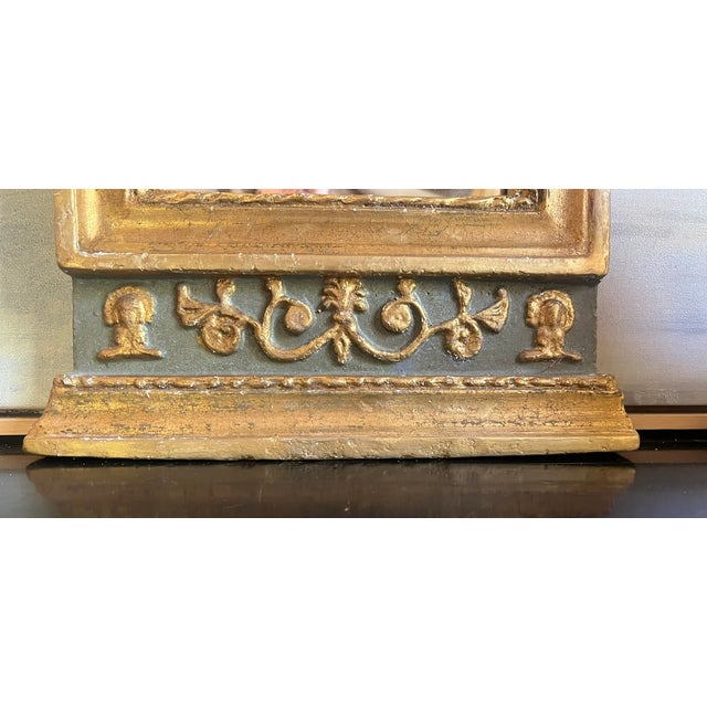 Regency style mirror from the 19th century. Plaster over wood, painted gold and gray.