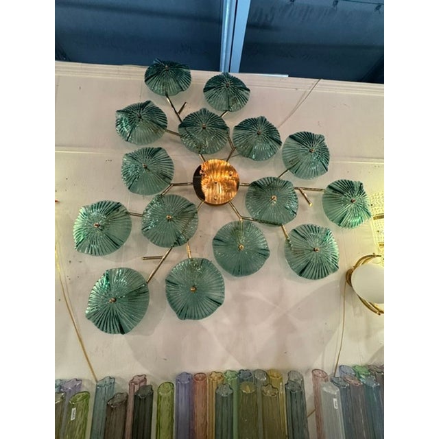 The Murano Green Glass Disc Wall Art Sconce is a stylish and unique piece of home decor that adds a touch of elegance to...