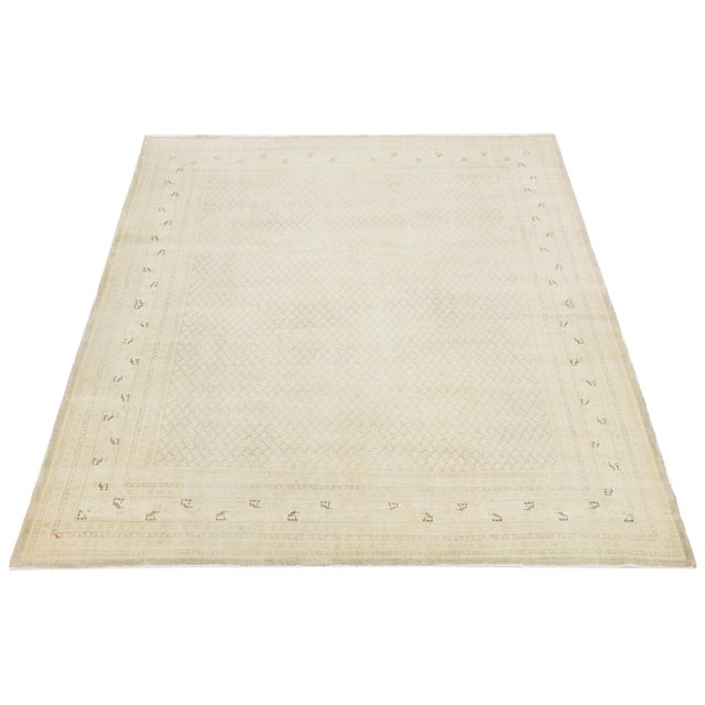 Persian Tabriz rug features a refined lattice field framed by a delicate border of stylized floral motifs. Woven in soft...