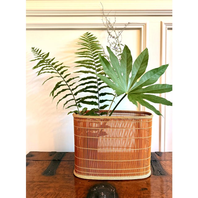 A Japanese bamboo flower basket (ikebana) by Koide Busei (1960-) in 2007 and originally purchased from Tai Modern, Santa...