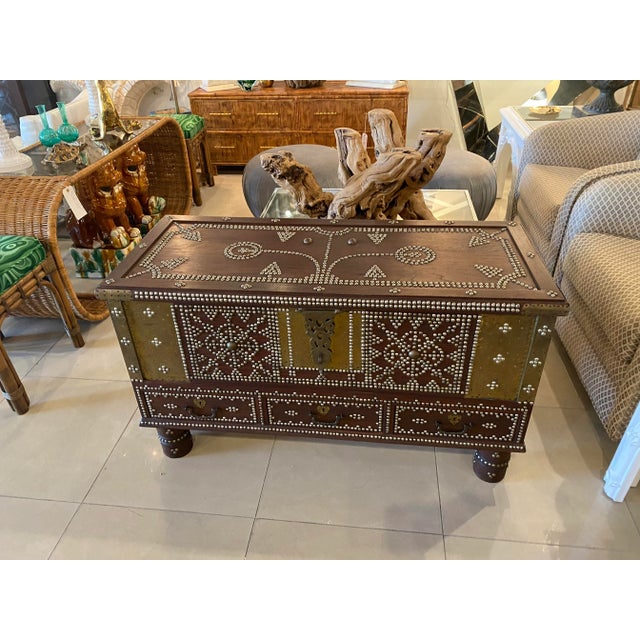 Lovely rare Zanzibar trunk, 19th century. Brass studded decorations all-over. Three bottom drawers and top opens for...