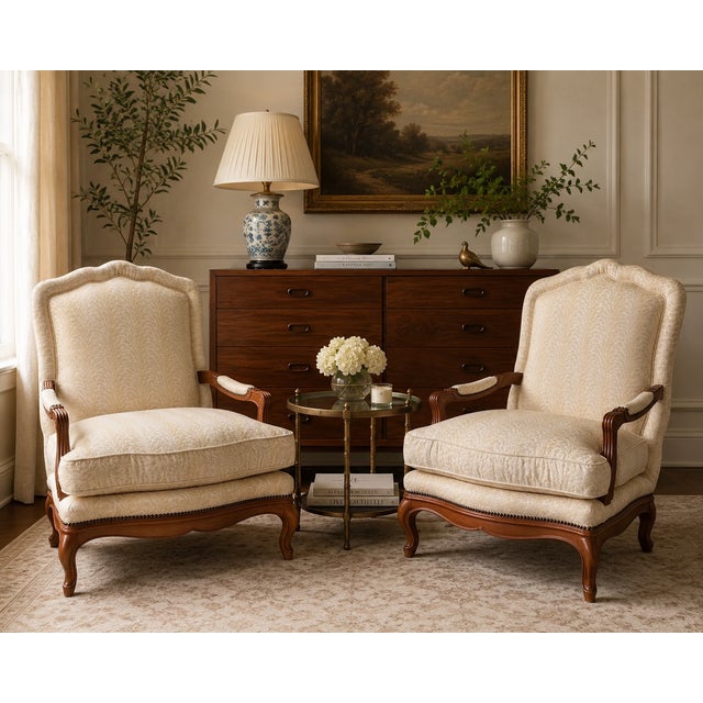 A rare and gorgeous pair of French Provincial Louis XV-style upholstered lounge chairs, crafted by Baker Furniture in the...