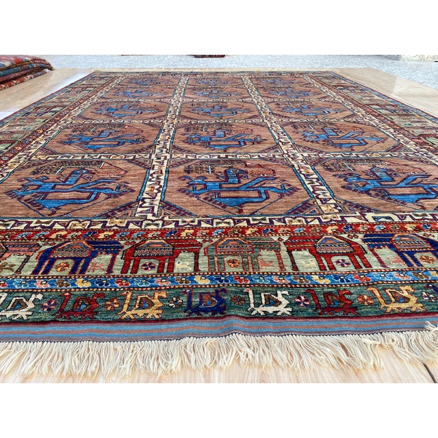 This vintage rug is hand-knotted in wool, woven in Afghanistan in the Ersari Turkomen tribal design tradition. Measuring...