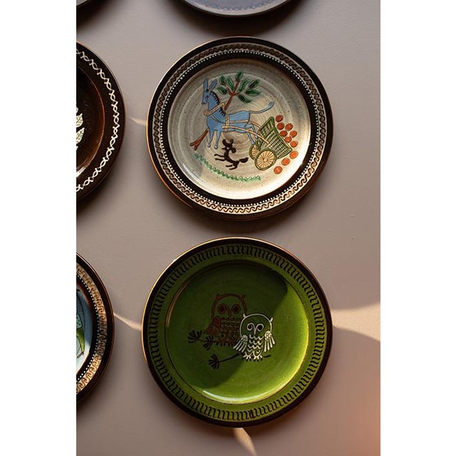 Elevate your space with this stunning, highly collectible curated gallery set of nine (9) vintage mid-century Swiss folk...