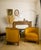 An elegant pair of Art Deco barrel chairs in solid wood, resting on fluted legs. They retain their original upholstery and...