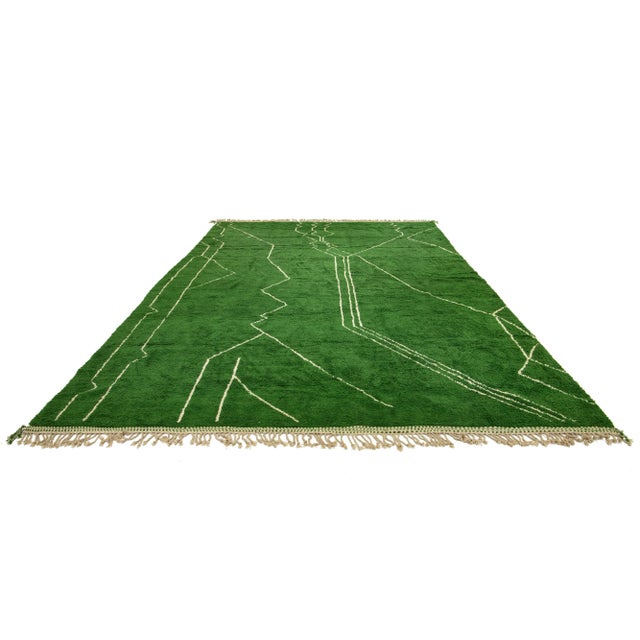 This hand-knotted organic wool rug features a contemporary Moroccan tribal pattern. This piece has beige accents that...