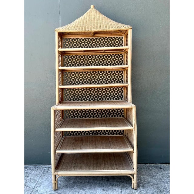 This étagère makes a distinctive architectural statement, its silhouette crowned by a dramatic pagoda-inspired roof that...