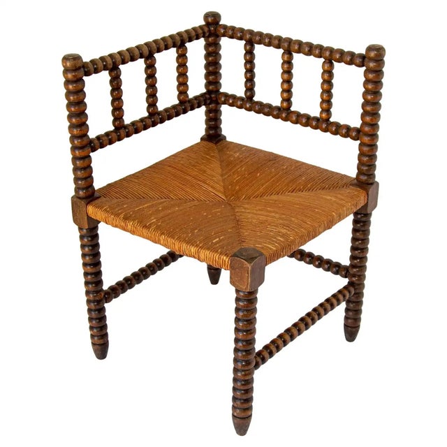 French Coin-de-Feu Bobbin-Turned Oak Corner Chair with Rush Seat, circa 1895 An engaging late-19th-century French corner...