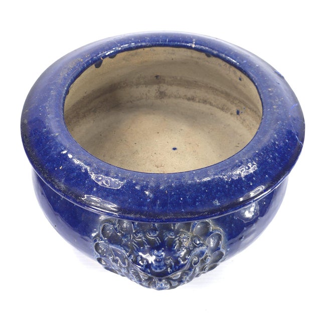 Lovey deep cobalt blue ceramic planter bowl with matching lion heads on two sides. Interior dimension is 9" in diameter...