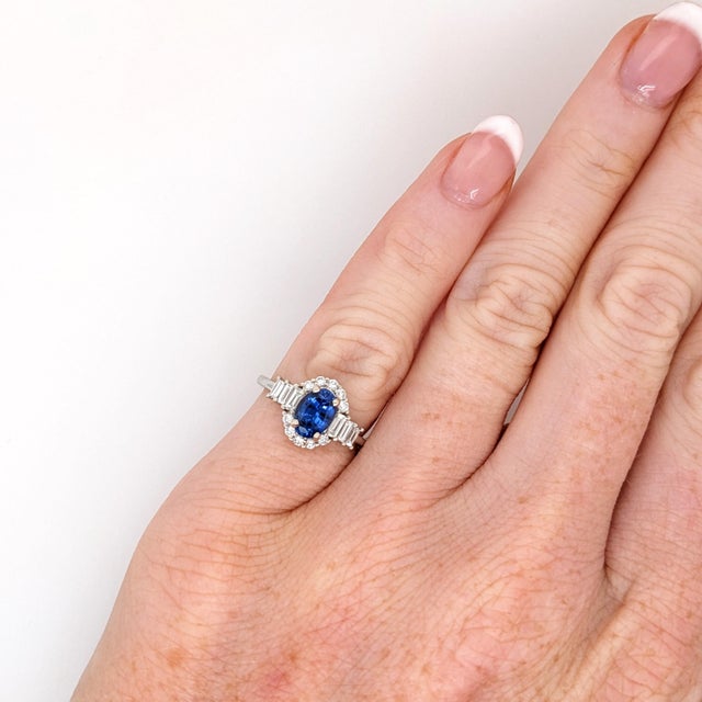 This gorgeous ring design showcases an oval cut Royal Blue Ceylon Sapphire with cascading baguette diamond accents all set...