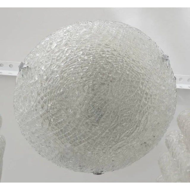 This flush mount chandelier was produced in the 1970s and is very much in the style of pieces created by the iconic firm...